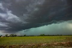 Dramatic dark storm clouds and a massive shelf cloud sweeping across the rural landscape near Elk City, Oklahoma, during the severe weather outbreak of April 14, 2026. Extreme weather photography by storm chaser Mauro Greco