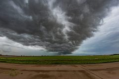 Dramatic dark storm clouds and a massive shelf cloud sweeping across the rural landscape near Elk City, Oklahoma, during the severe weather outbreak of April 14, 2026. Extreme weather photography by storm chaser Mauro Greco