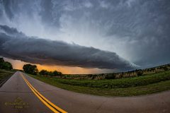 Dramatic dark storm clouds and a massive shelf cloud sweeping across the rural landscape near Elk City, Oklahoma, during the severe weather outbreak of April 14, 2026. Extreme weather photography by storm chaser Mauro Greco
