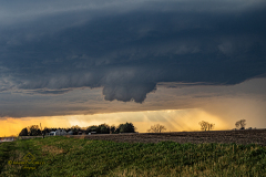 A massive, highly structured supercell thunderstorm dominates the sky over the rural plains near Brantford, Kansas, during the severe weather event of April 9, 2026. Extreme weather photography by storm chaser Mauro Greco
