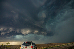 A massive, highly structured supercell thunderstorm dominates the sky over the rural plains near Brantford, Kansas, during the severe weather event of April 9, 2026. Extreme weather photography by storm chaser Mauro Greco