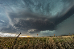 A massive, highly structured supercell thunderstorm dominates the sky over the rural plains near Brantford, Kansas, during the severe weather event of April 9, 2026. Extreme weather photography by storm chaser Mauro Greco
