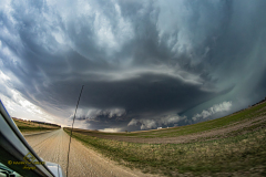 A massive, highly structured supercell thunderstorm dominates the sky over the rural plains near Brantford, Kansas, during the severe weather event of April 9, 2026. Extreme weather photography by storm chaser Mauro Greco