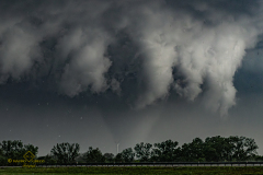 Massive Tornado and rapidly rotating wall cloud and ominous severe supercell thunderstorm dominate the sky over the plains near Braman, Oklahoma, on April 23, 2026. This intense atmospheric structure and mesocyclone preceded a dangerous rain-wrapped tornado. Extreme weather photography and storm chasing by Mauro Greco.